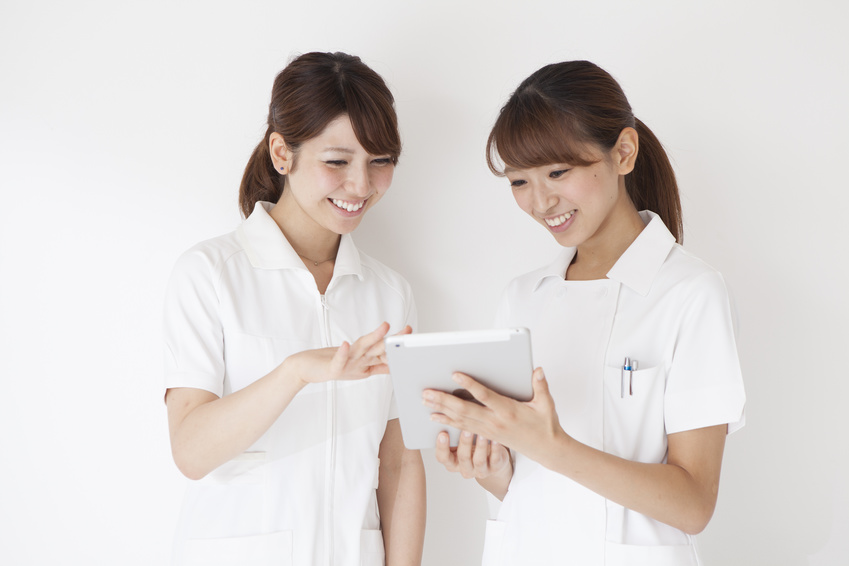 Two women nurses are watching tablet